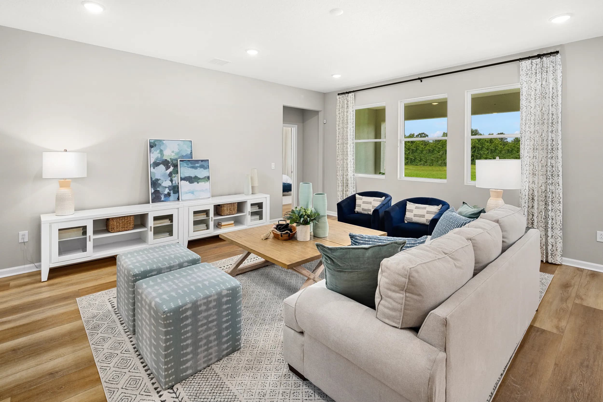Aster model living room with sectional and ottomans