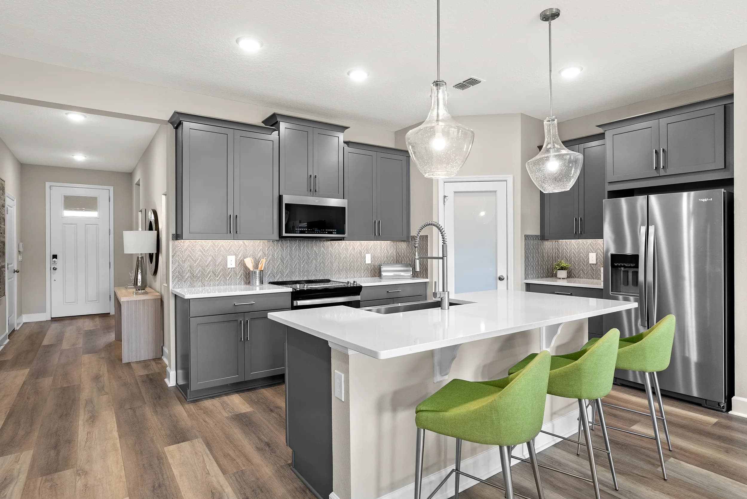 Glades model kitchen with green stools at Waterbrooke, Clermont