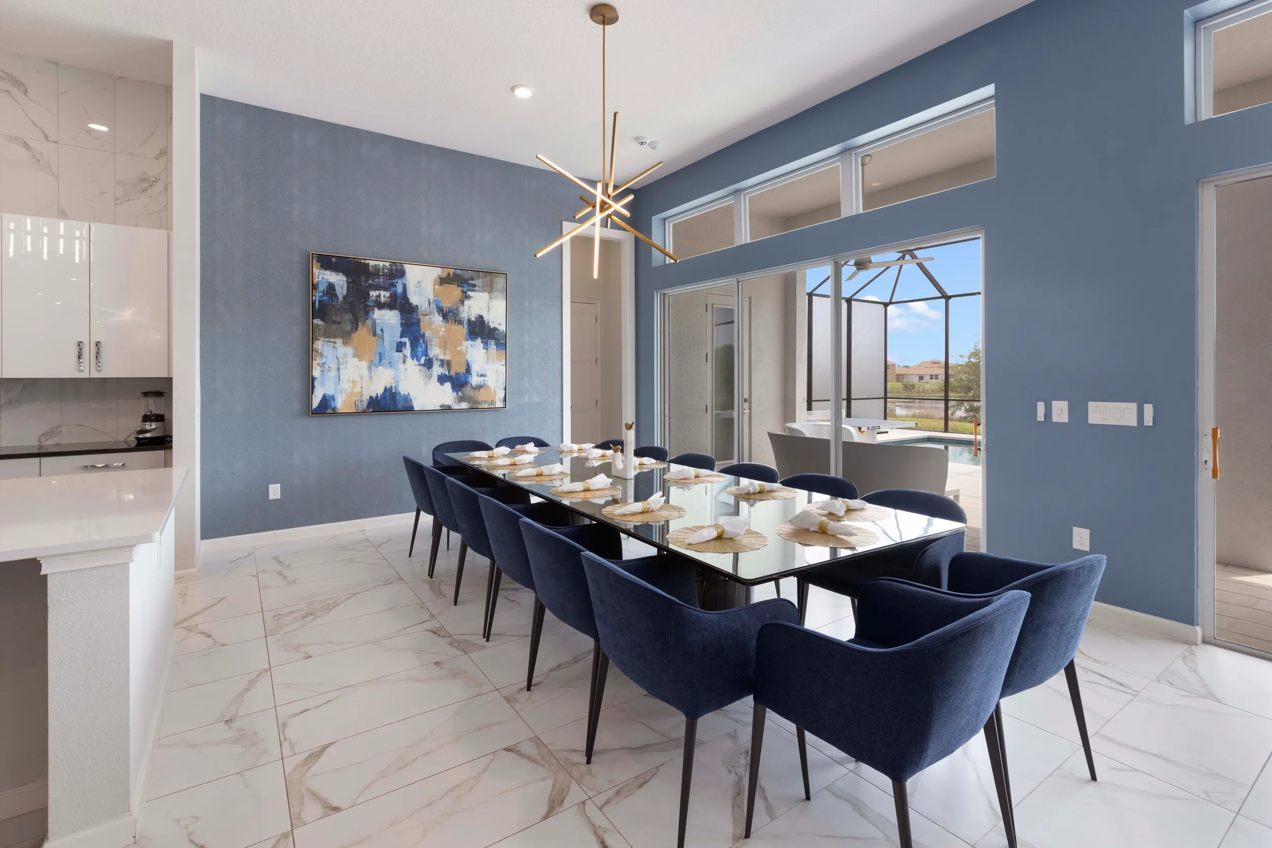 Dining room for twelve with navy chairs and a pool view