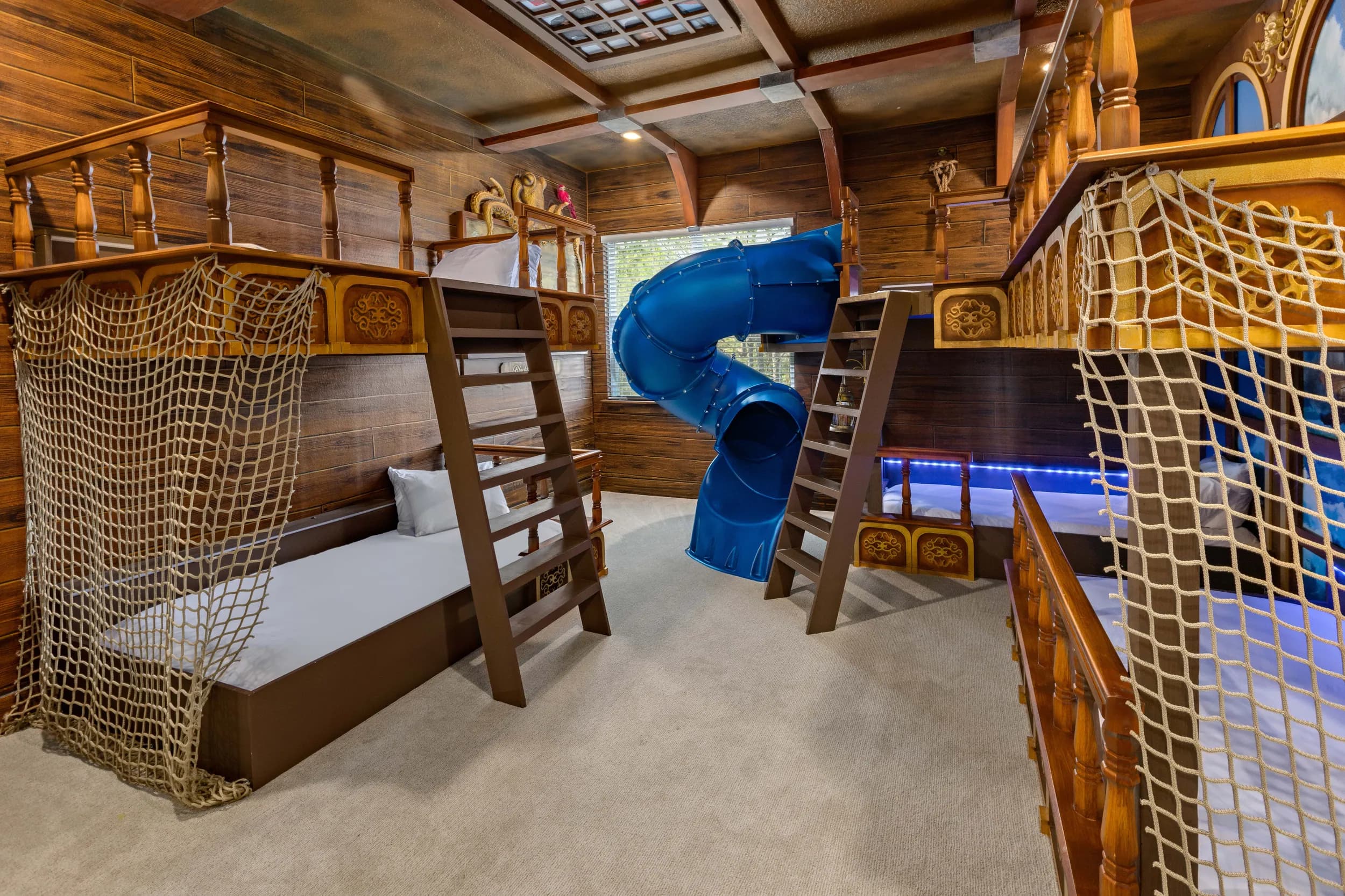 Pirate-ship bunk room with slide and rope nets