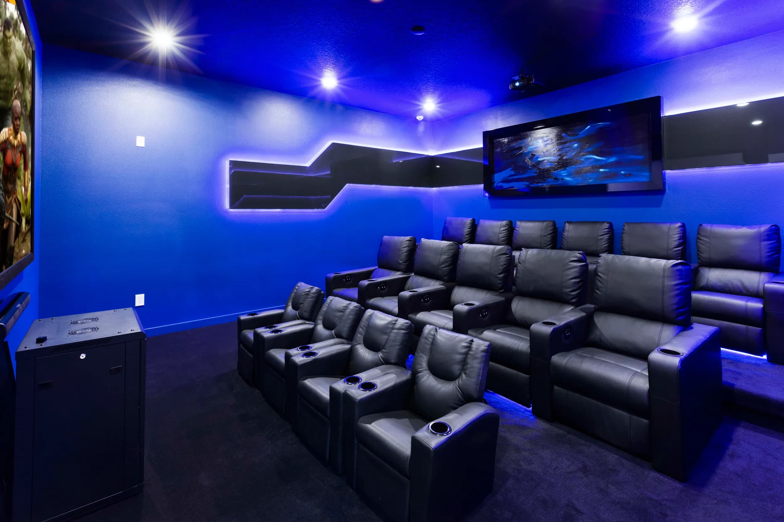 Home theater with leather recliners and a blue LED ceiling