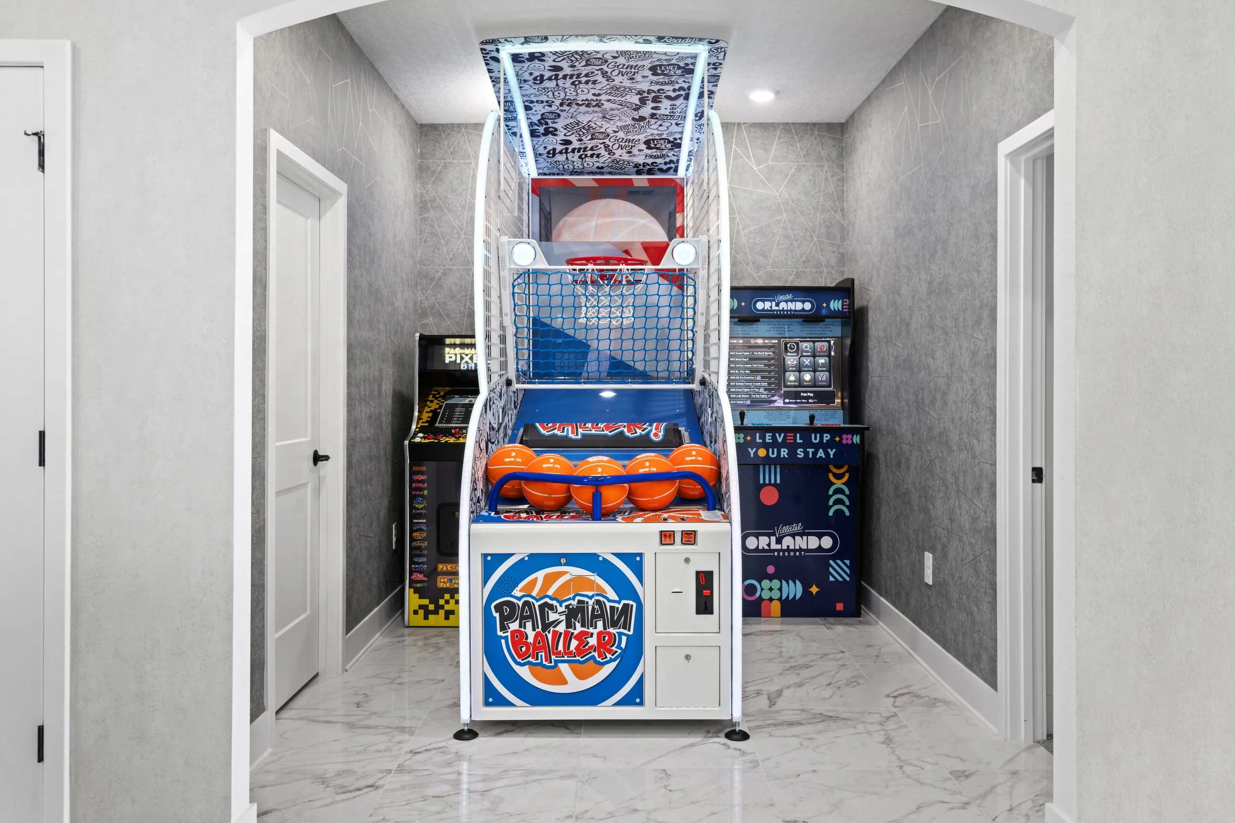Arcade room with a basketball machine and Pac-Man cabinet