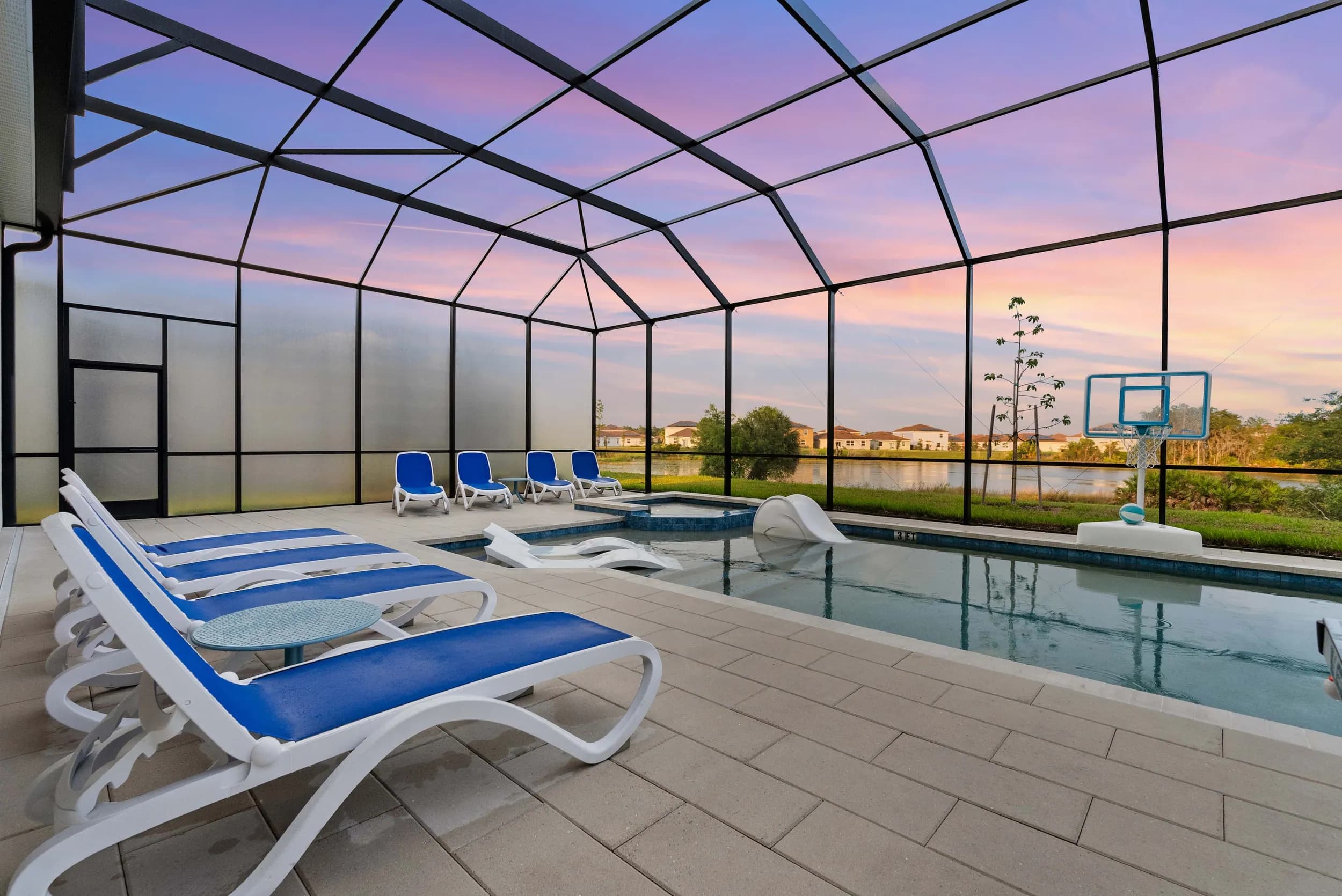 Screened pool and loungers at sunset