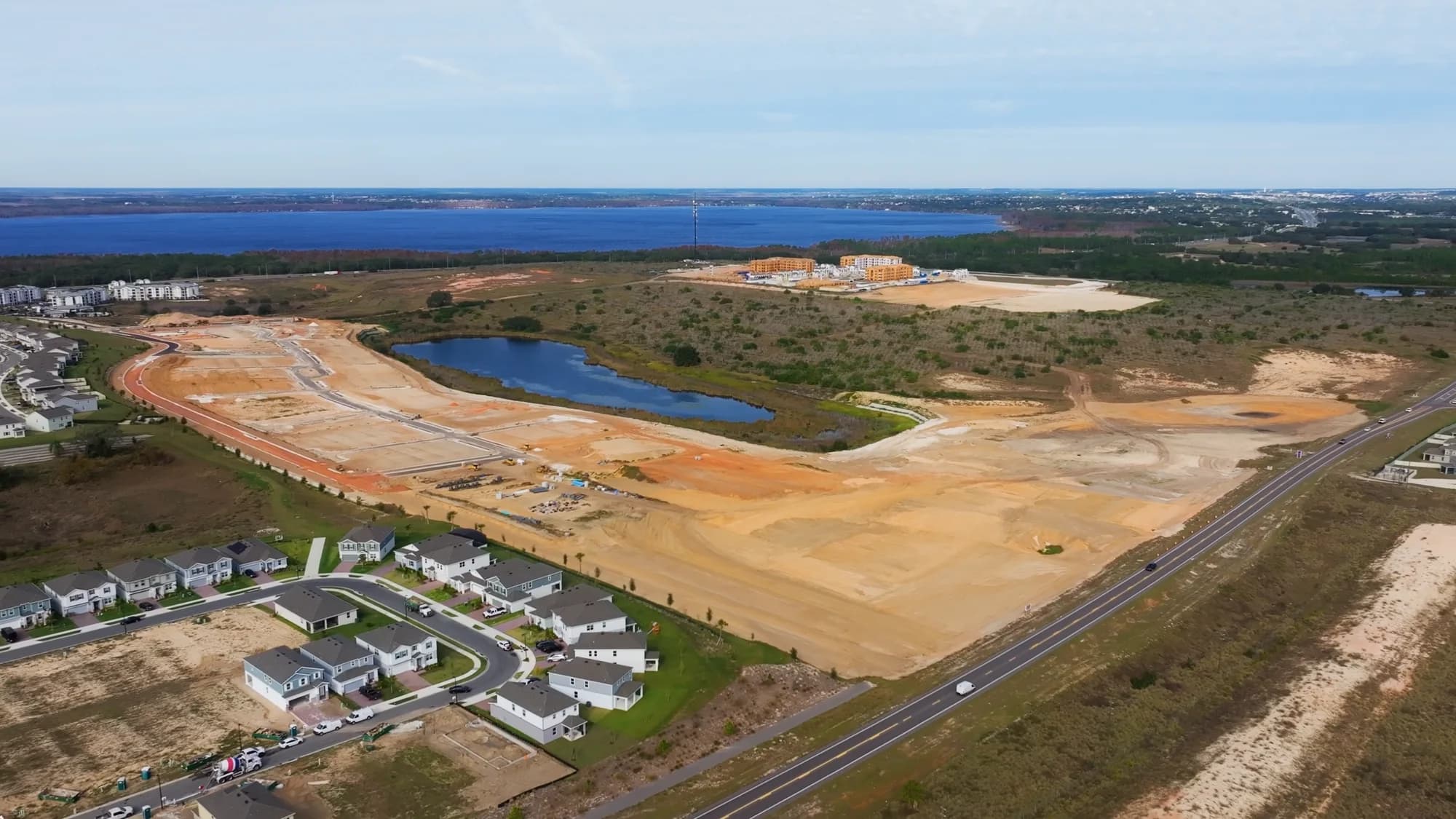 Graded home pads at a lakefront community with the delivered phase alongside