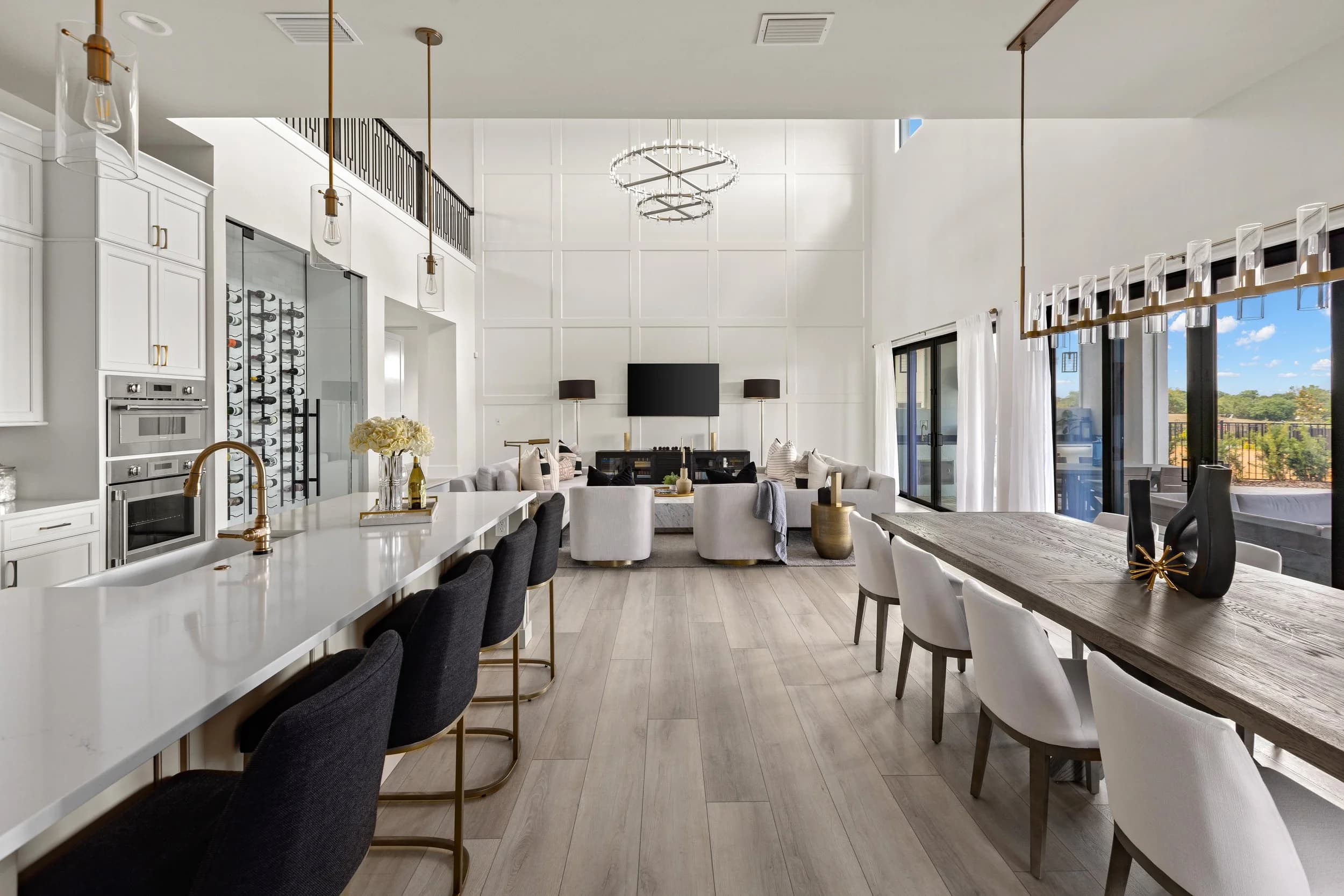 Model home kitchen and dining with island seating and chandelier