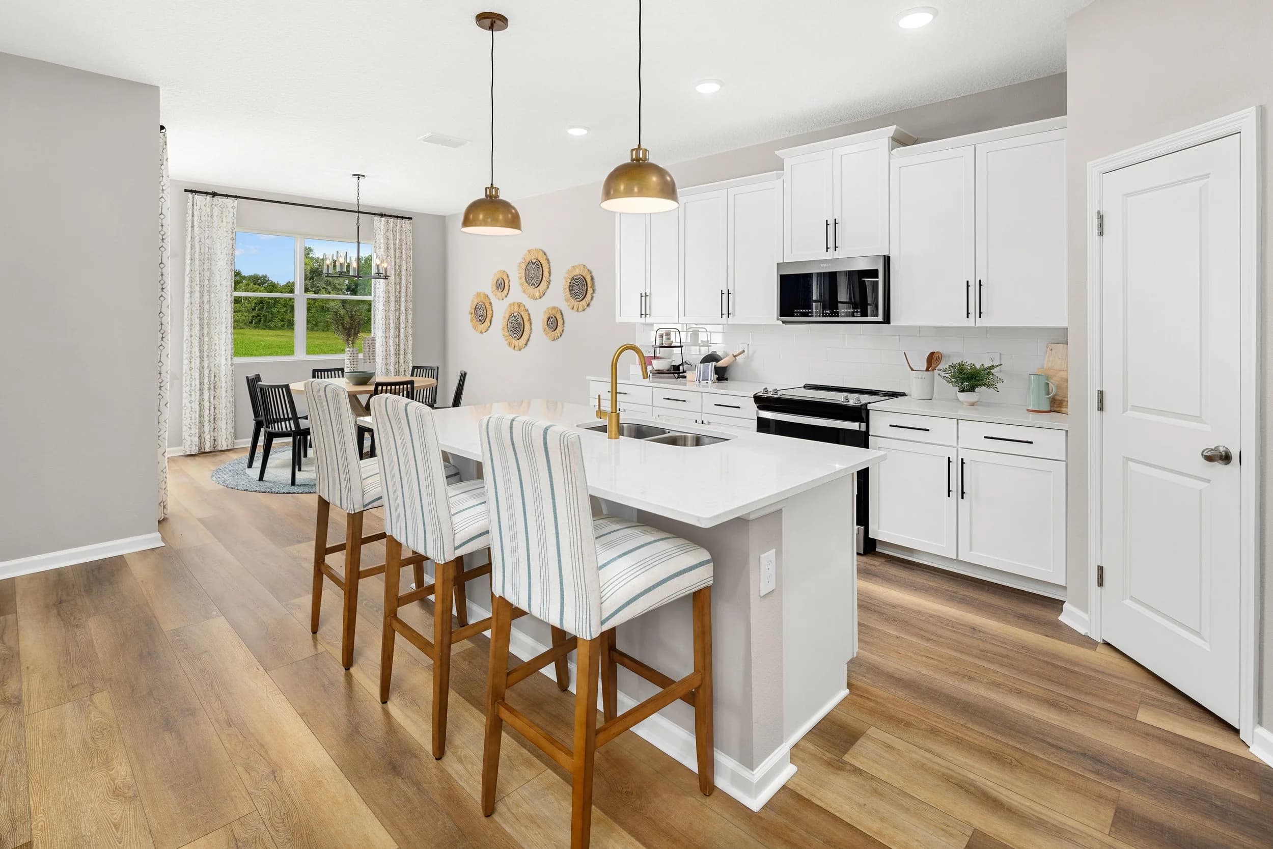 White model kitchen with island and pendant lights