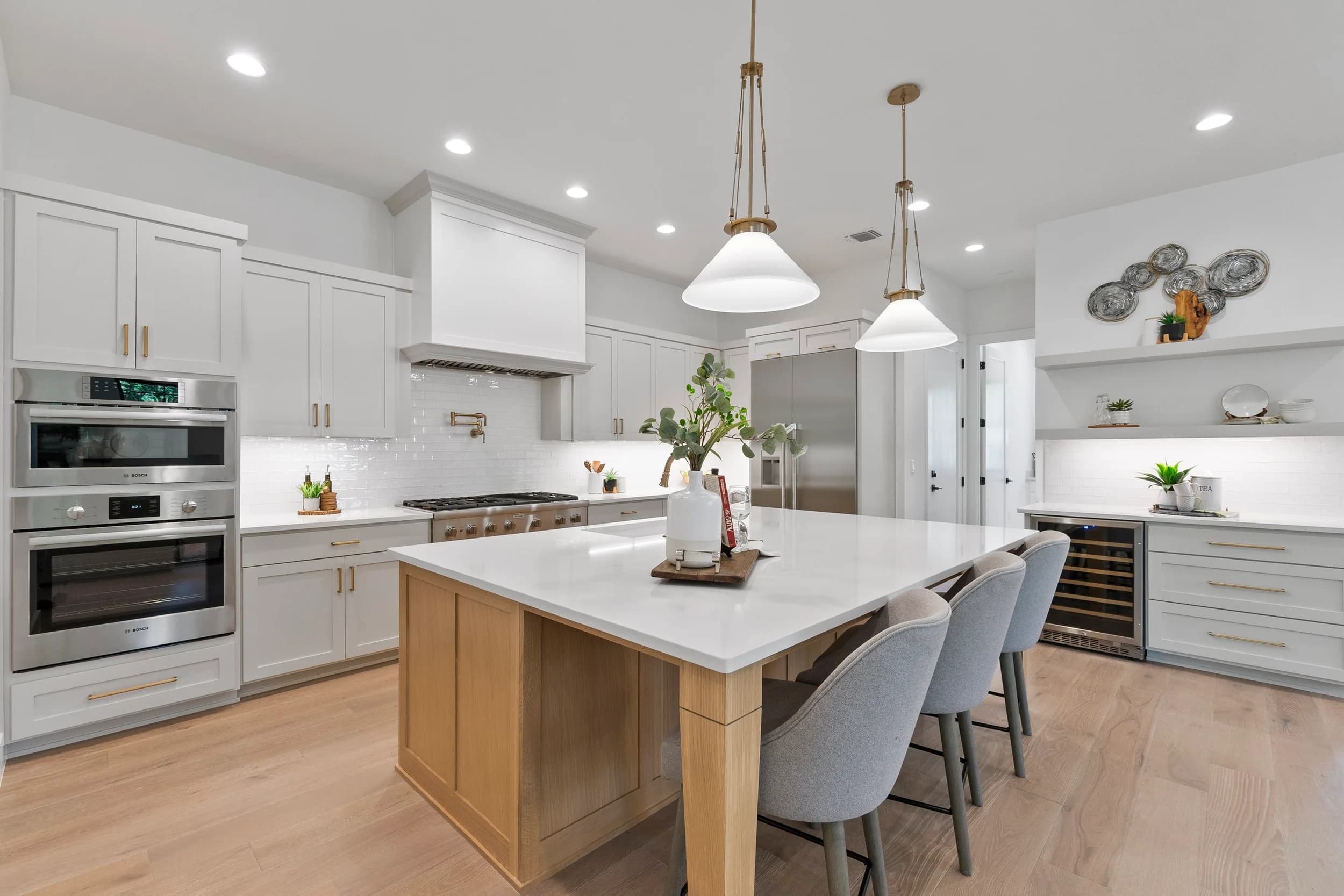New-build kitchen in Austin with white island and wood accents