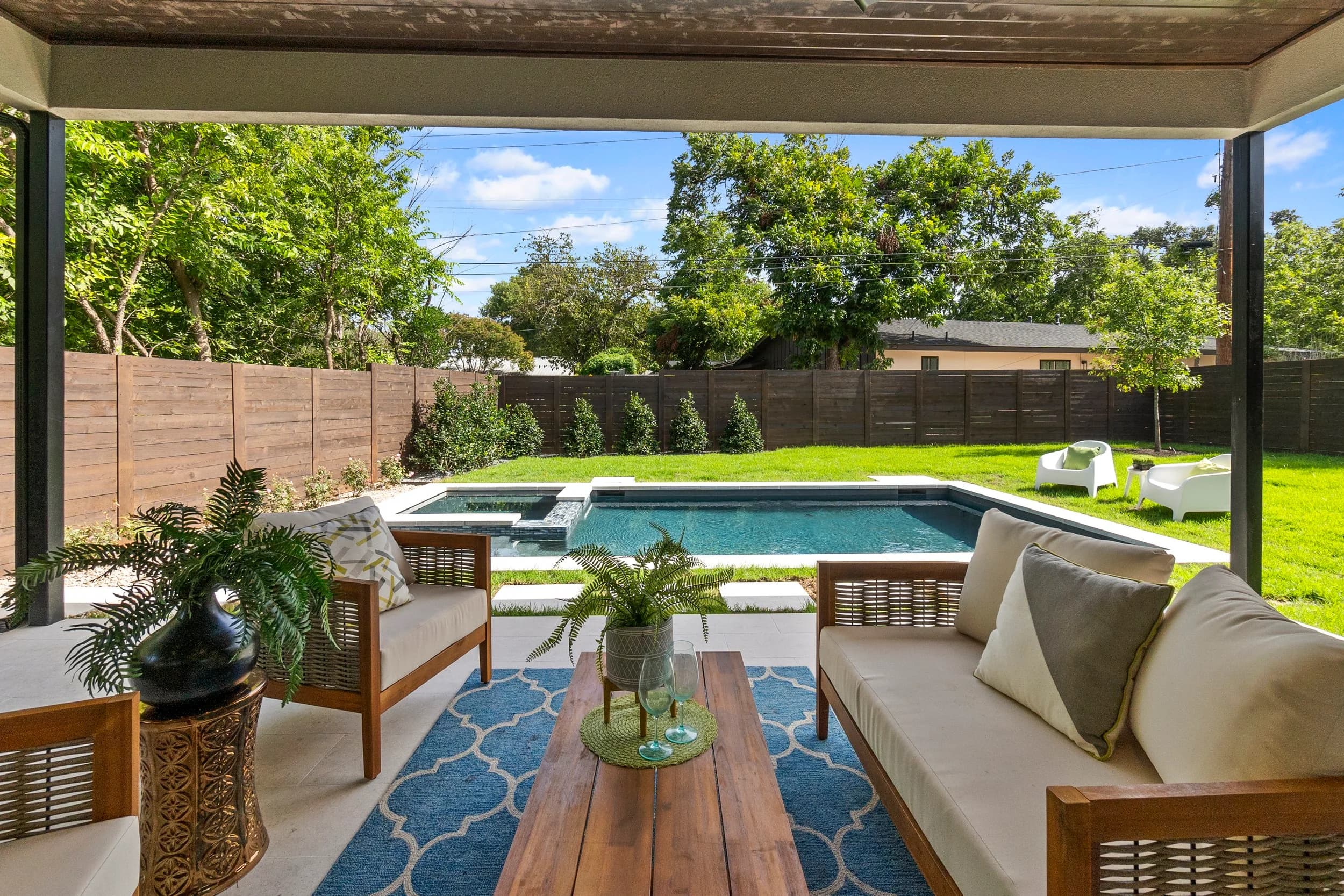 New-build covered patio in Austin opening to a pool