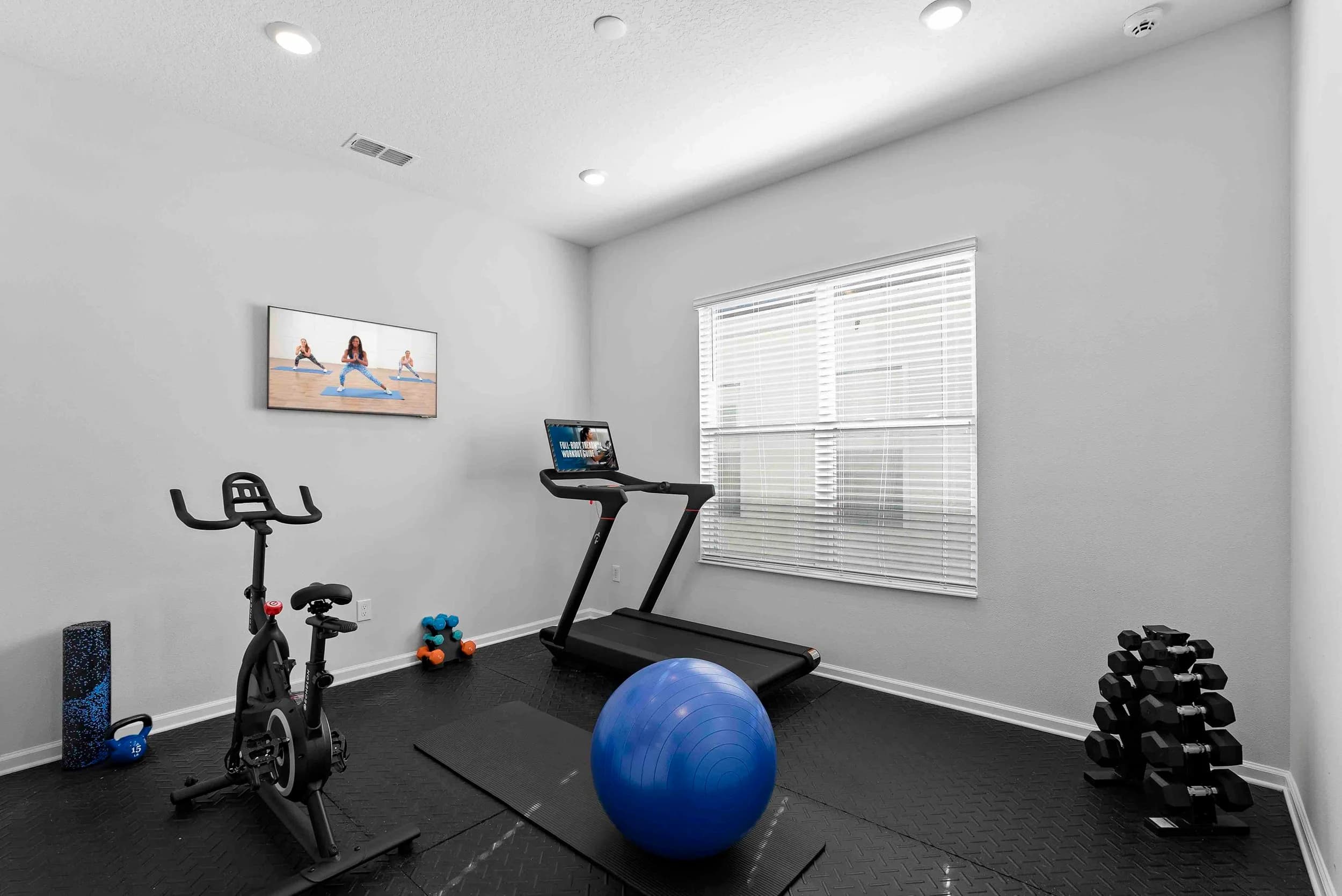 Home gym with treadmill and bike
