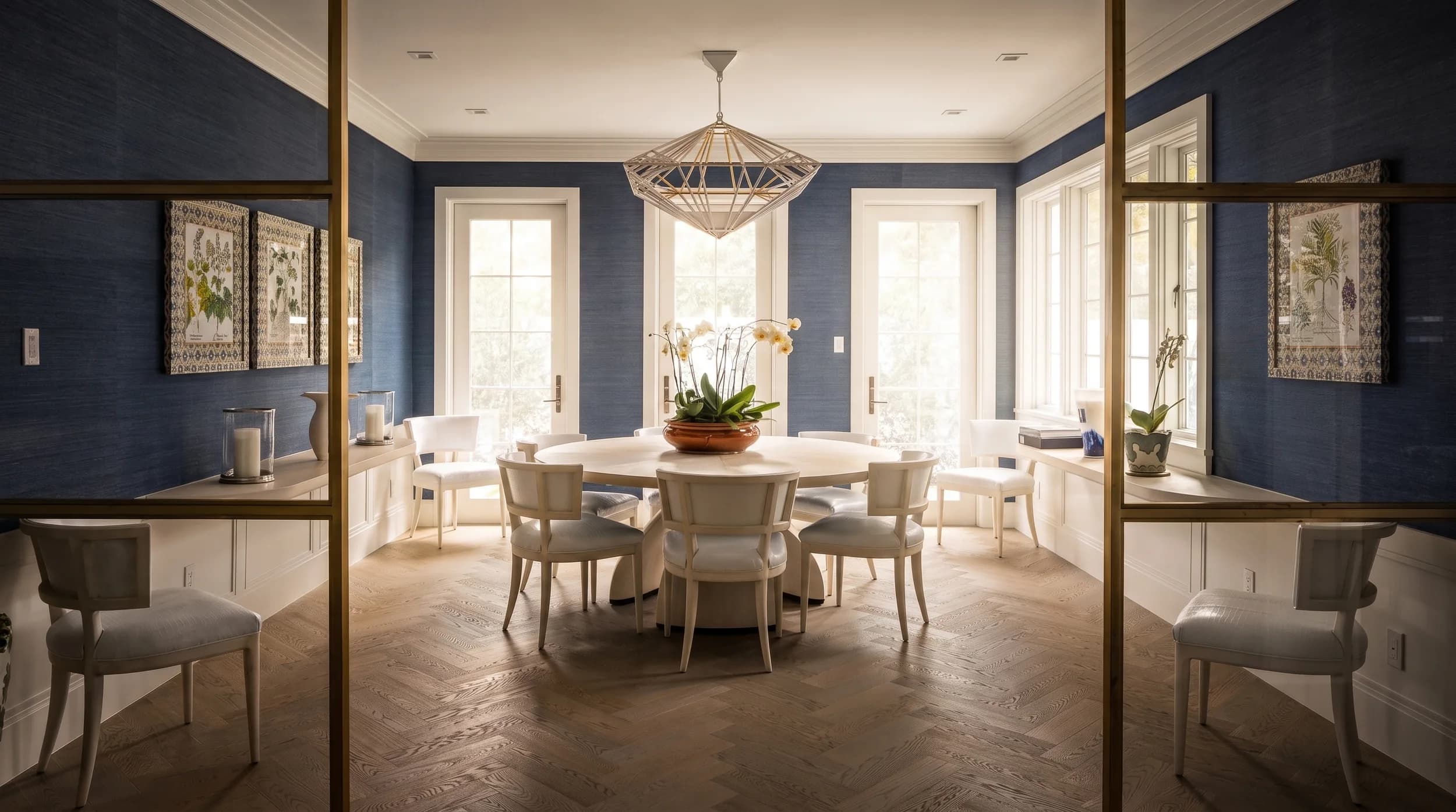 Formal dining room with navy grasscloth walls, herringbone oak floor, and a geometric brass chandelier