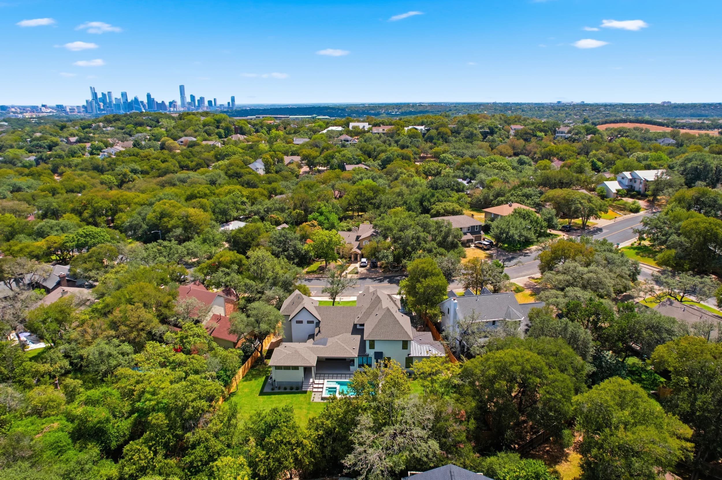 Aerial of a new Paradisa Homes build with the downtown Austin skyline, photographed by JRP
