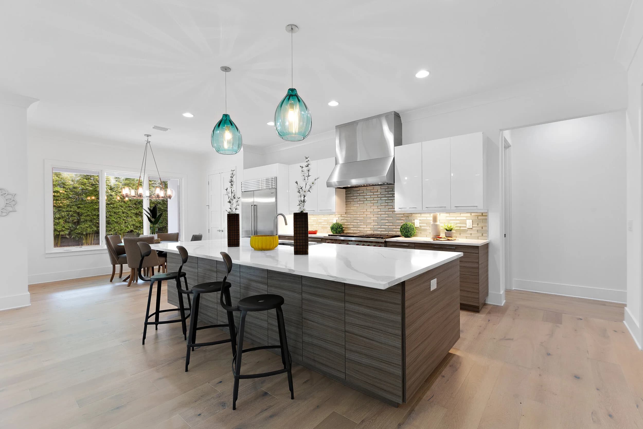 Kitchen with teal pendants and glass doors