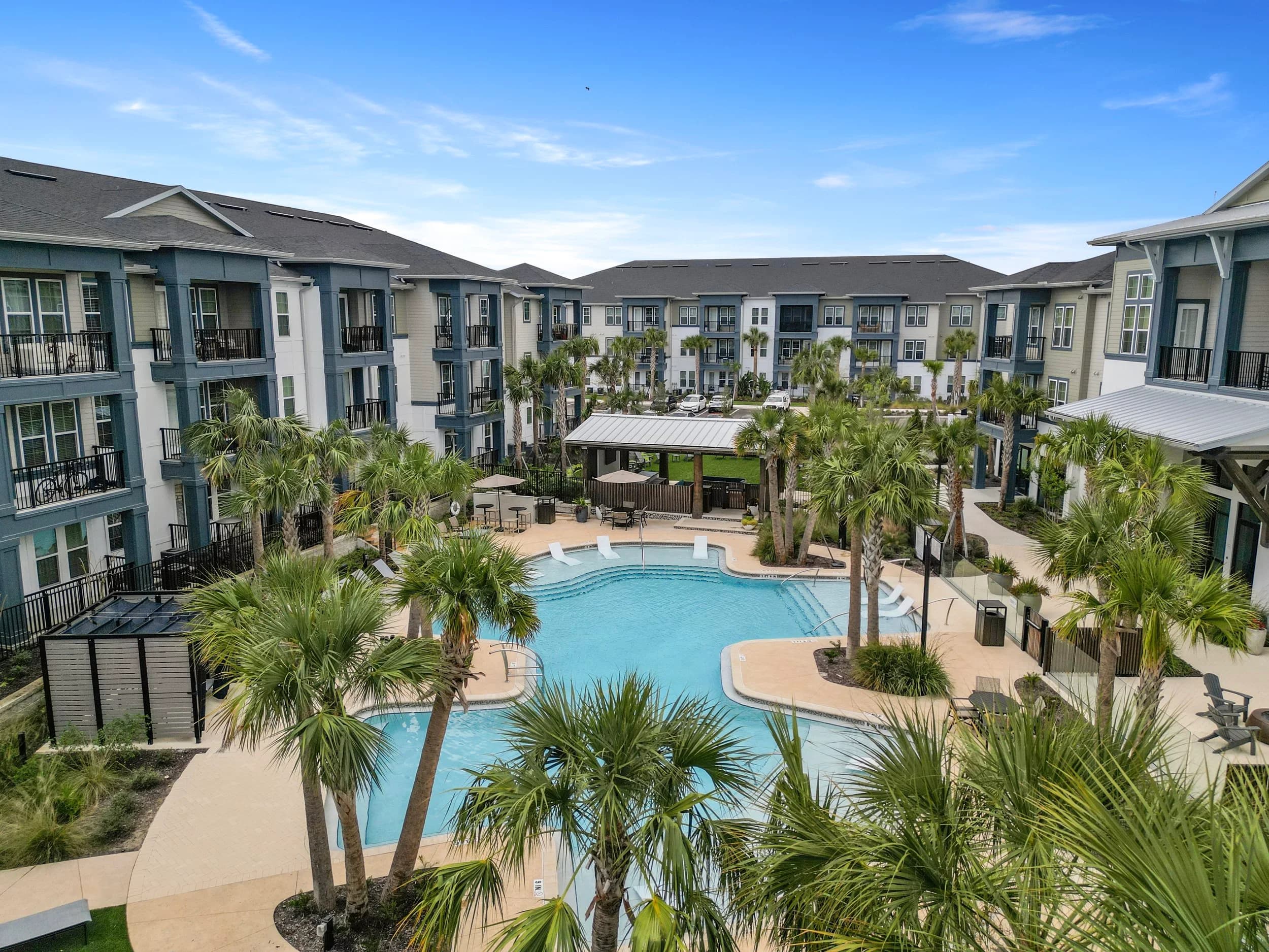Apartment community pool courtyard with palms