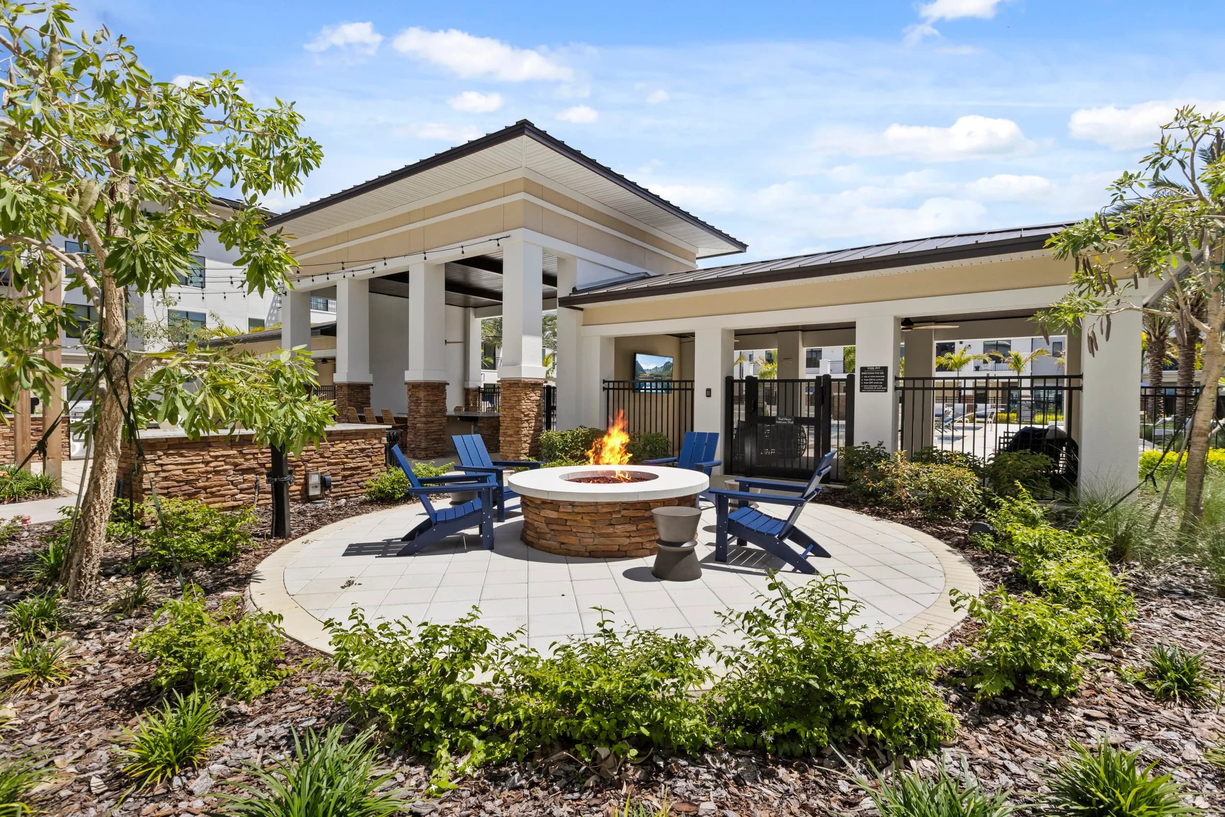 Community fire pit lounge under a covered pavilion