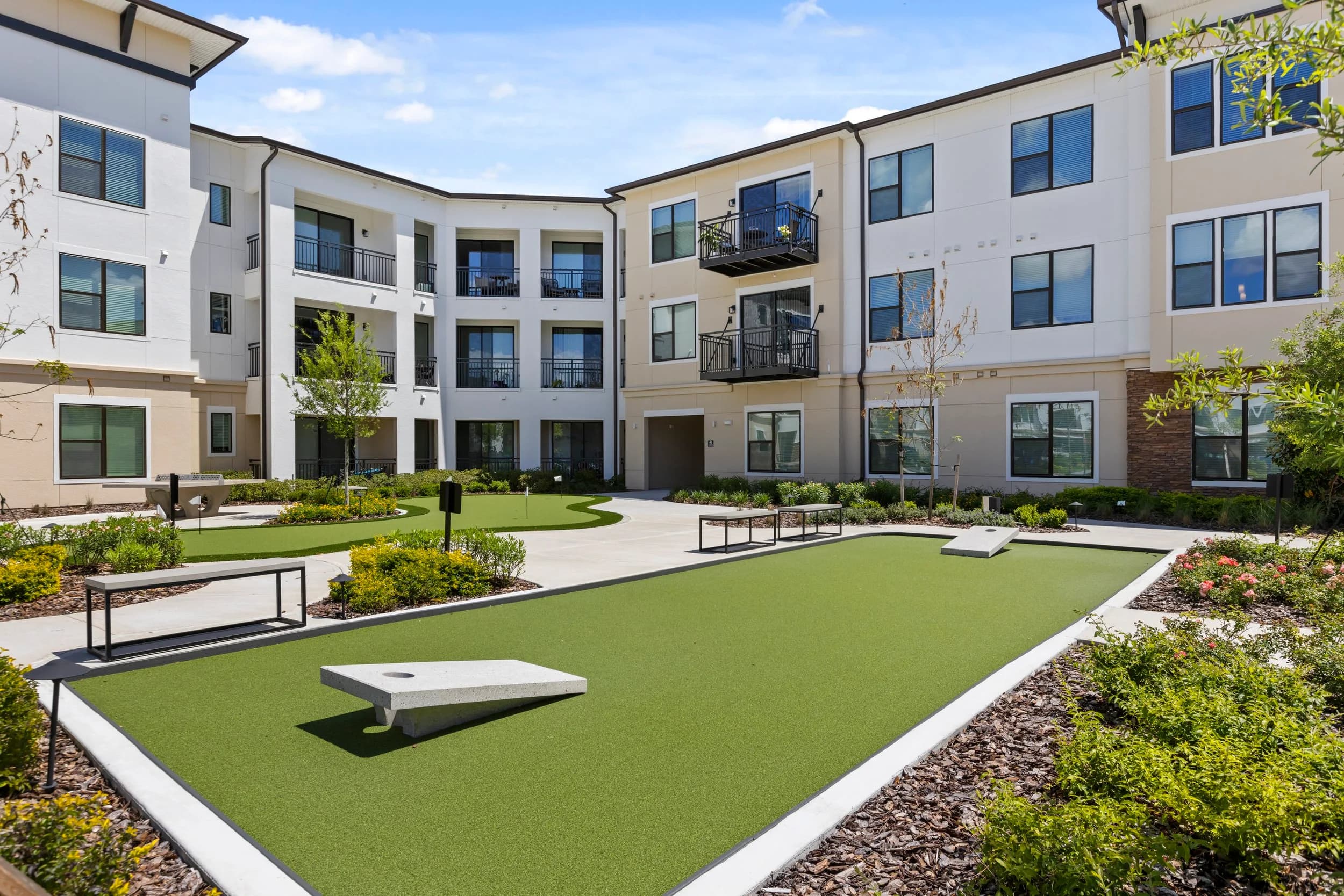 Cornhole lawn between apartment buildings