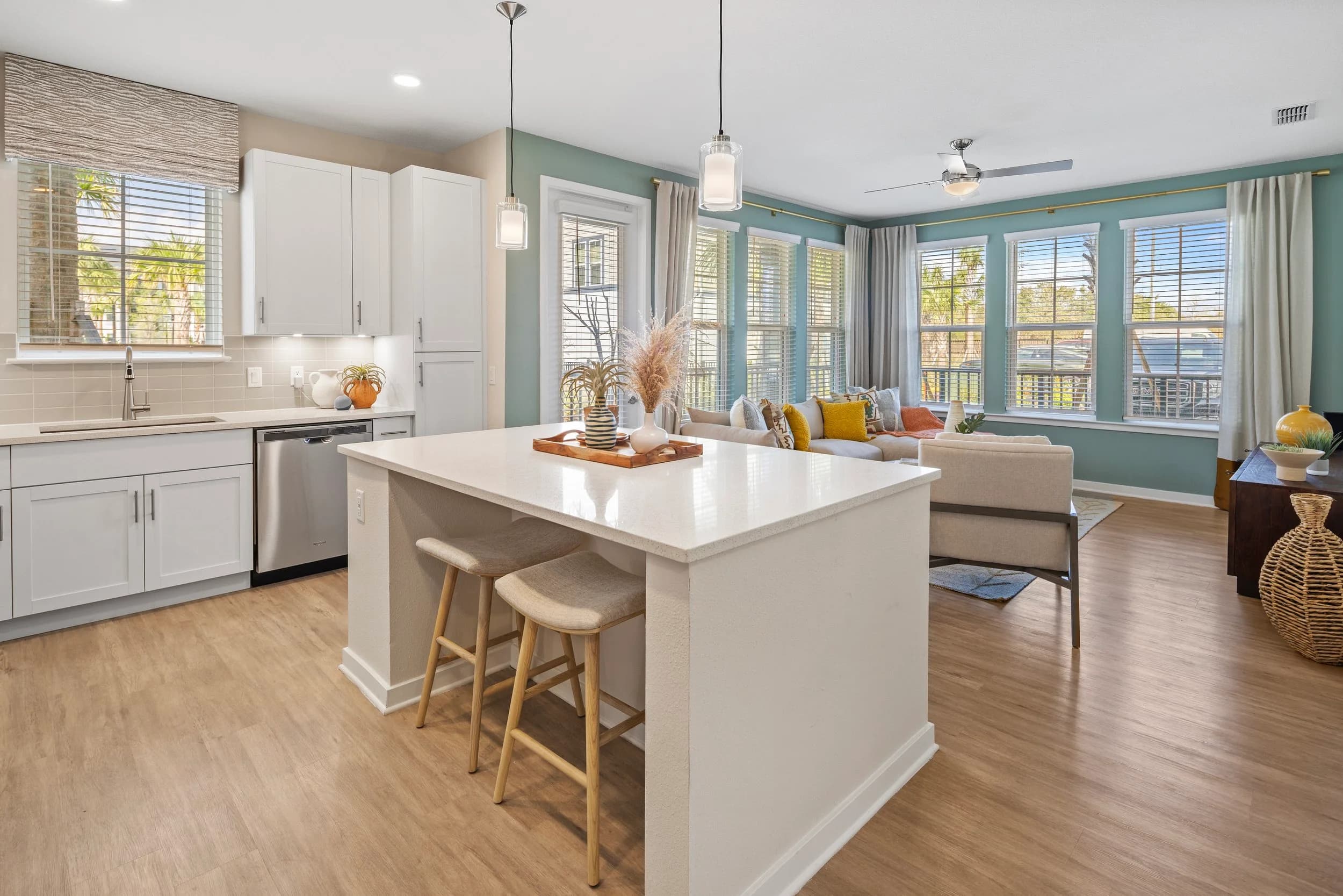 Model apartment kitchen with white island and bay window
