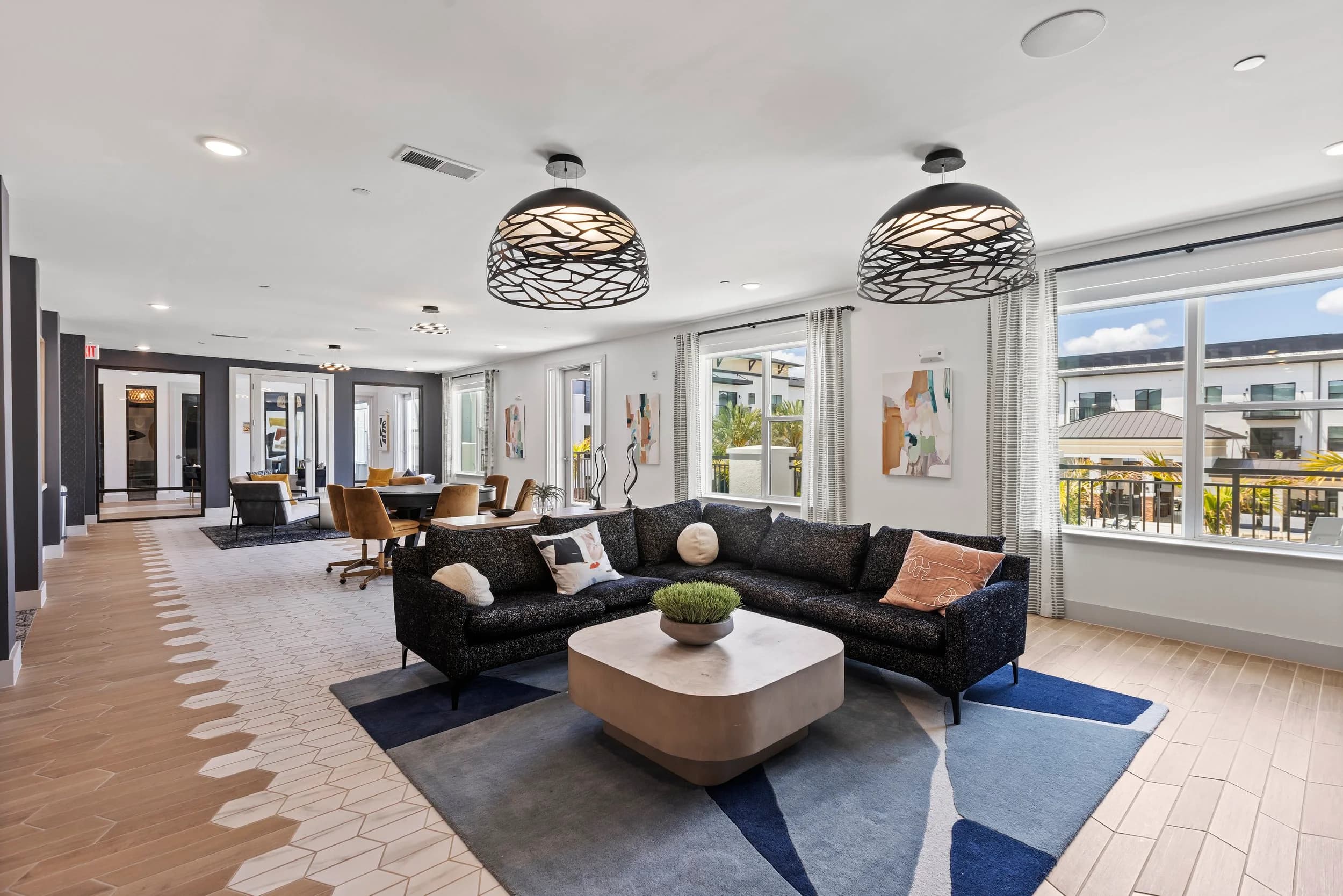 Resident lounge with sectional and pendant lights