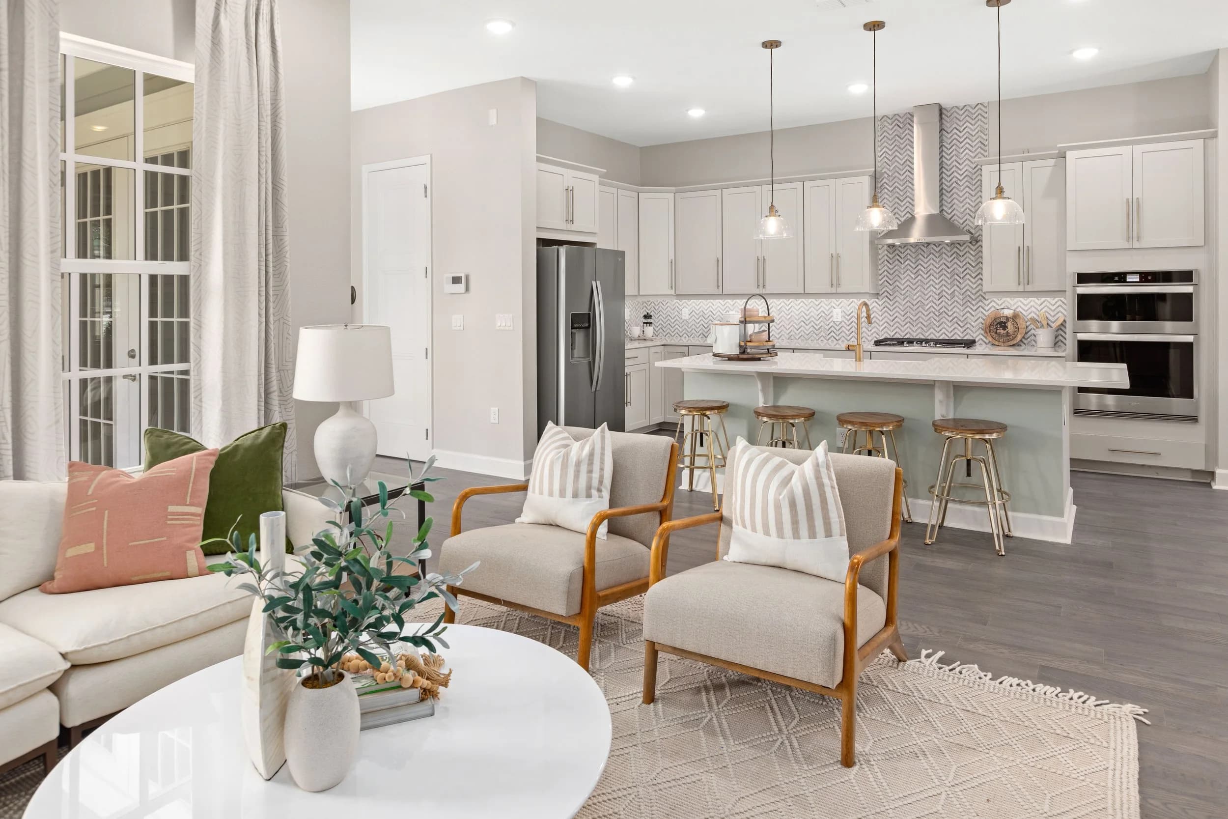 Bright white kitchen with island seating and pendant lights
