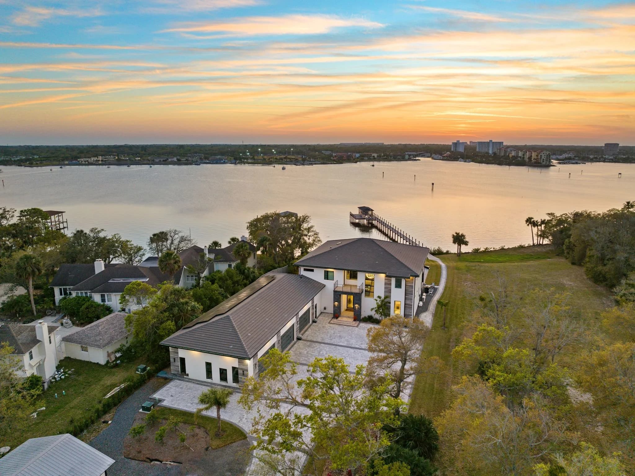 Aerial view of a lakefront home at sunset