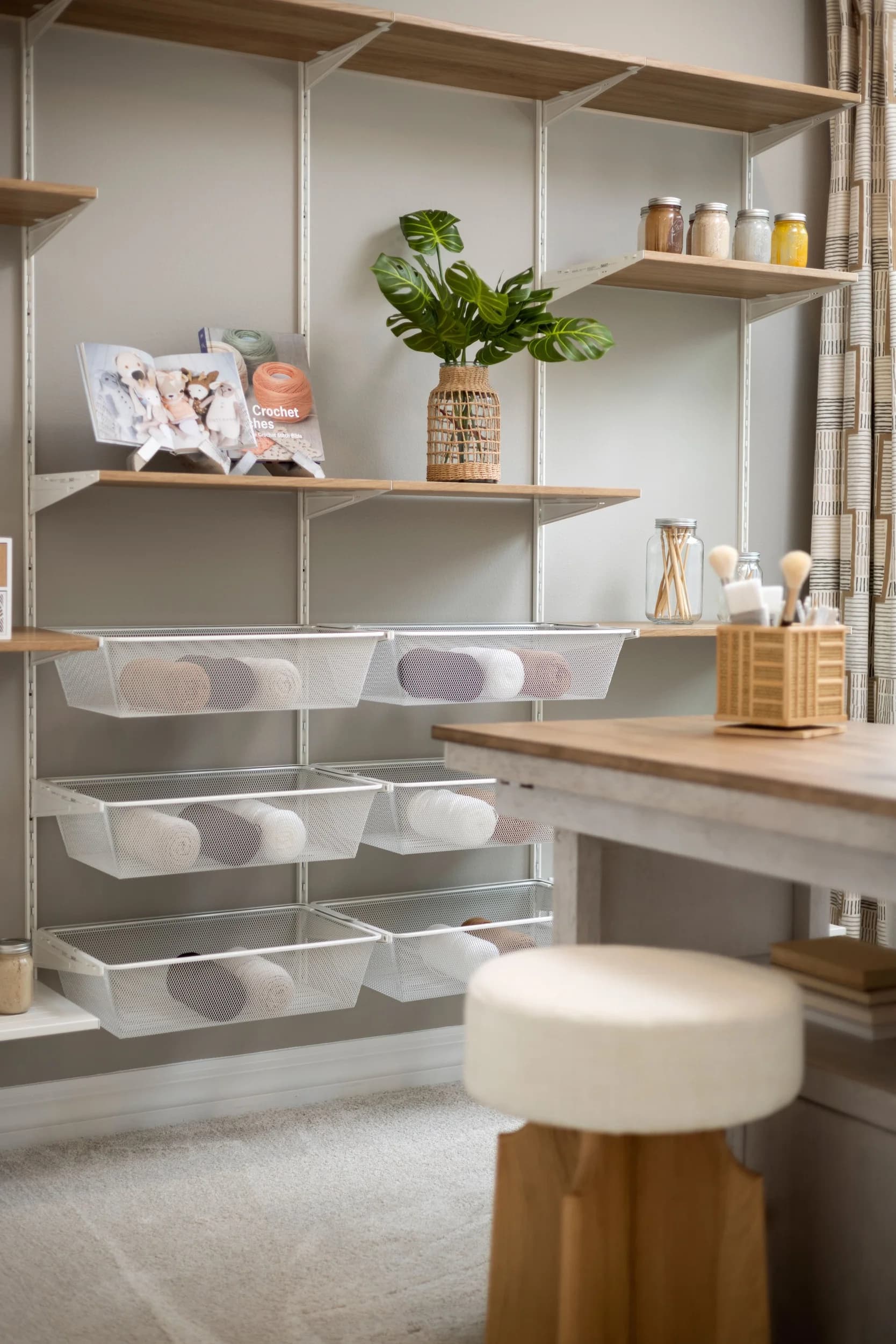 Styled pantry shelves with baskets, ceramics, and a wood ladder