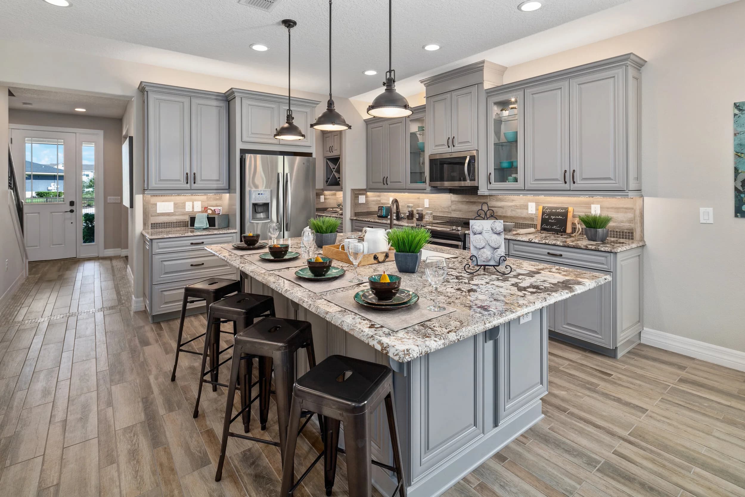 Model kitchen with gray cabinets and granite island
