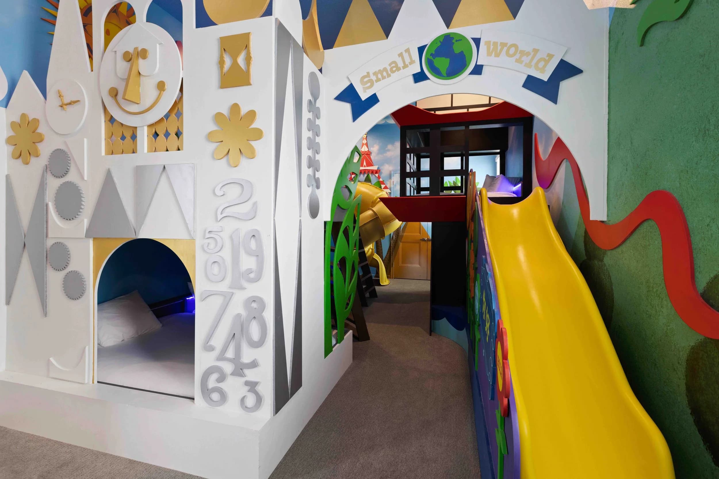Themed kids playroom with slide and murals