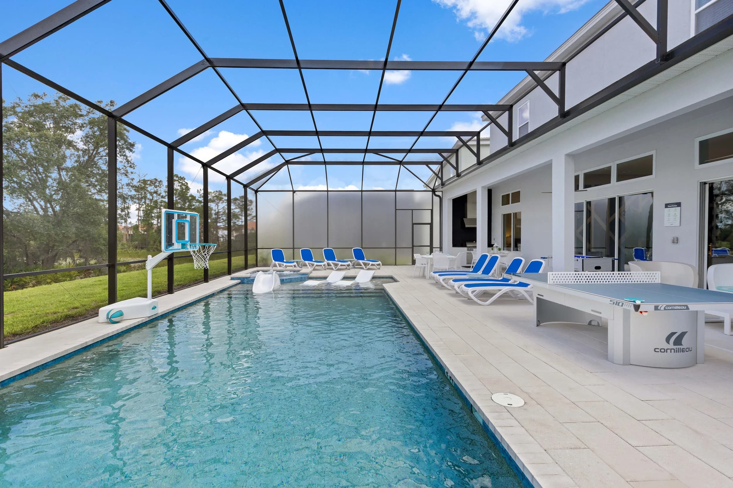 Screened pool with basketball hoop and lounge chairs