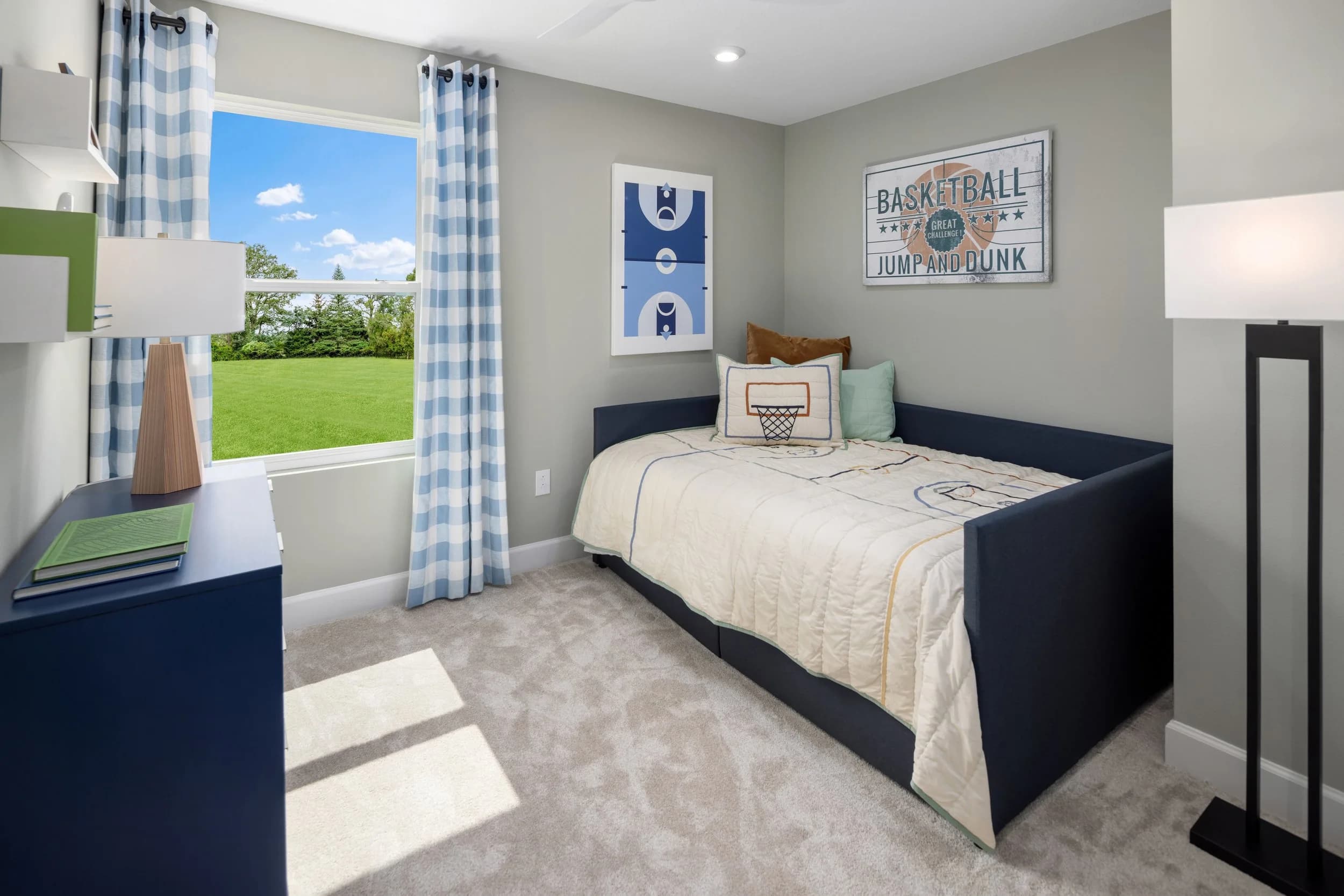 Kids bedroom with navy bed, blue gingham curtains and basketball wall art