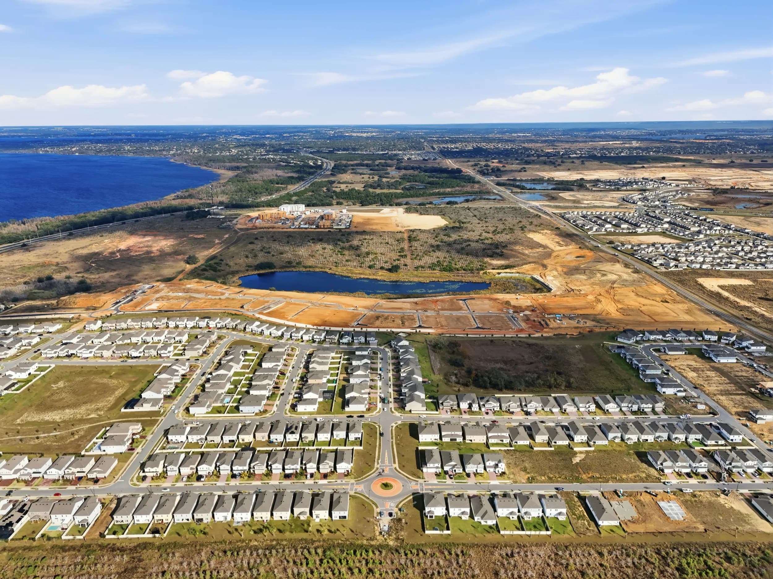 Aerial of the Olympus community in Clermont with finished streets, ponds and the lake beyond