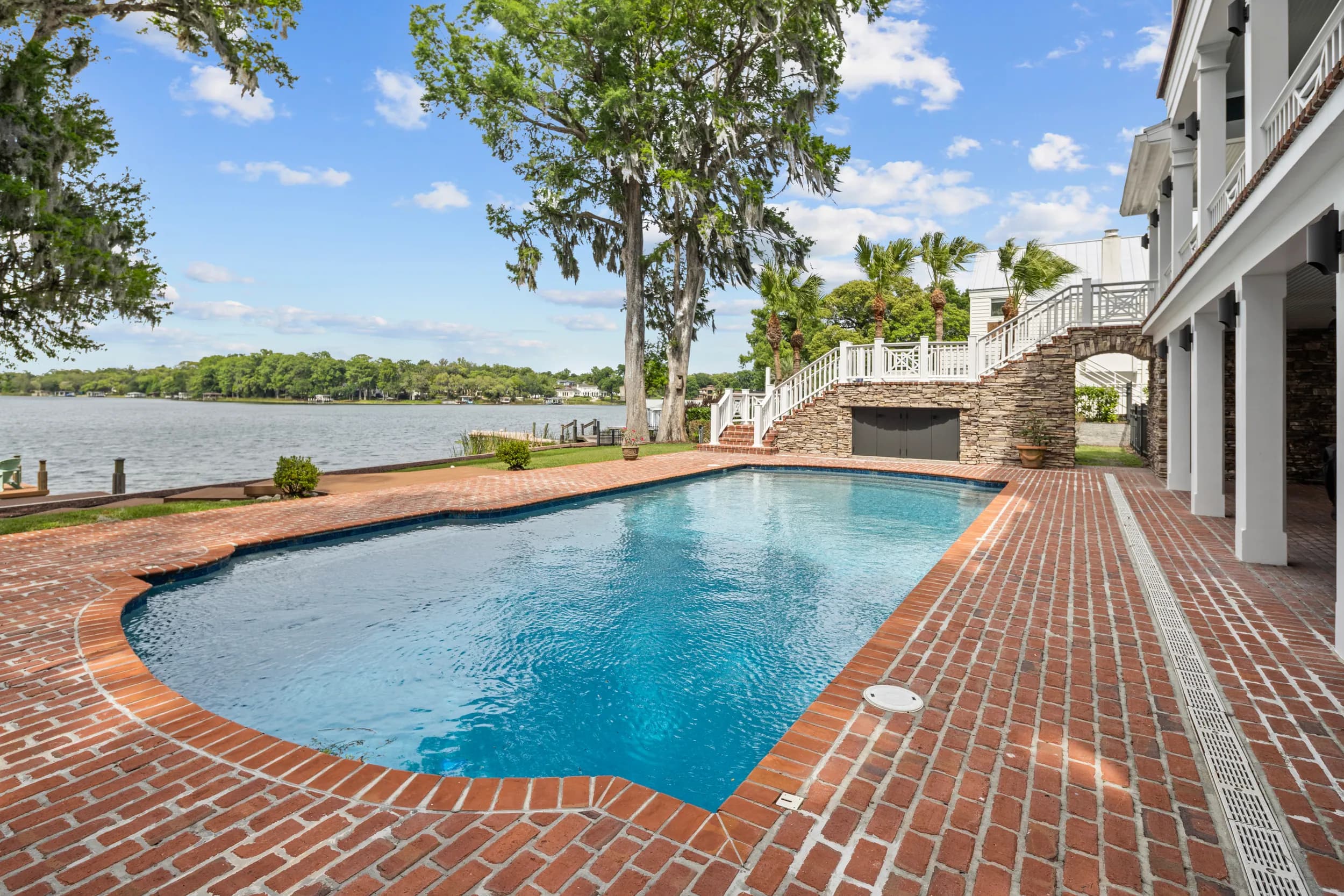 Brick-paved pool terrace beside the lake