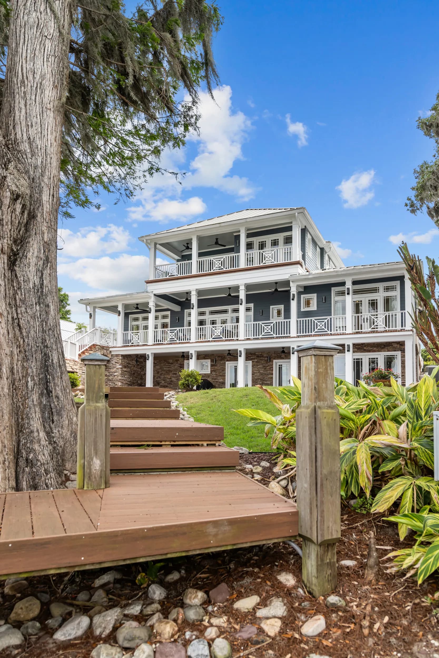 Rear elevation with three levels of porches, from the lawn