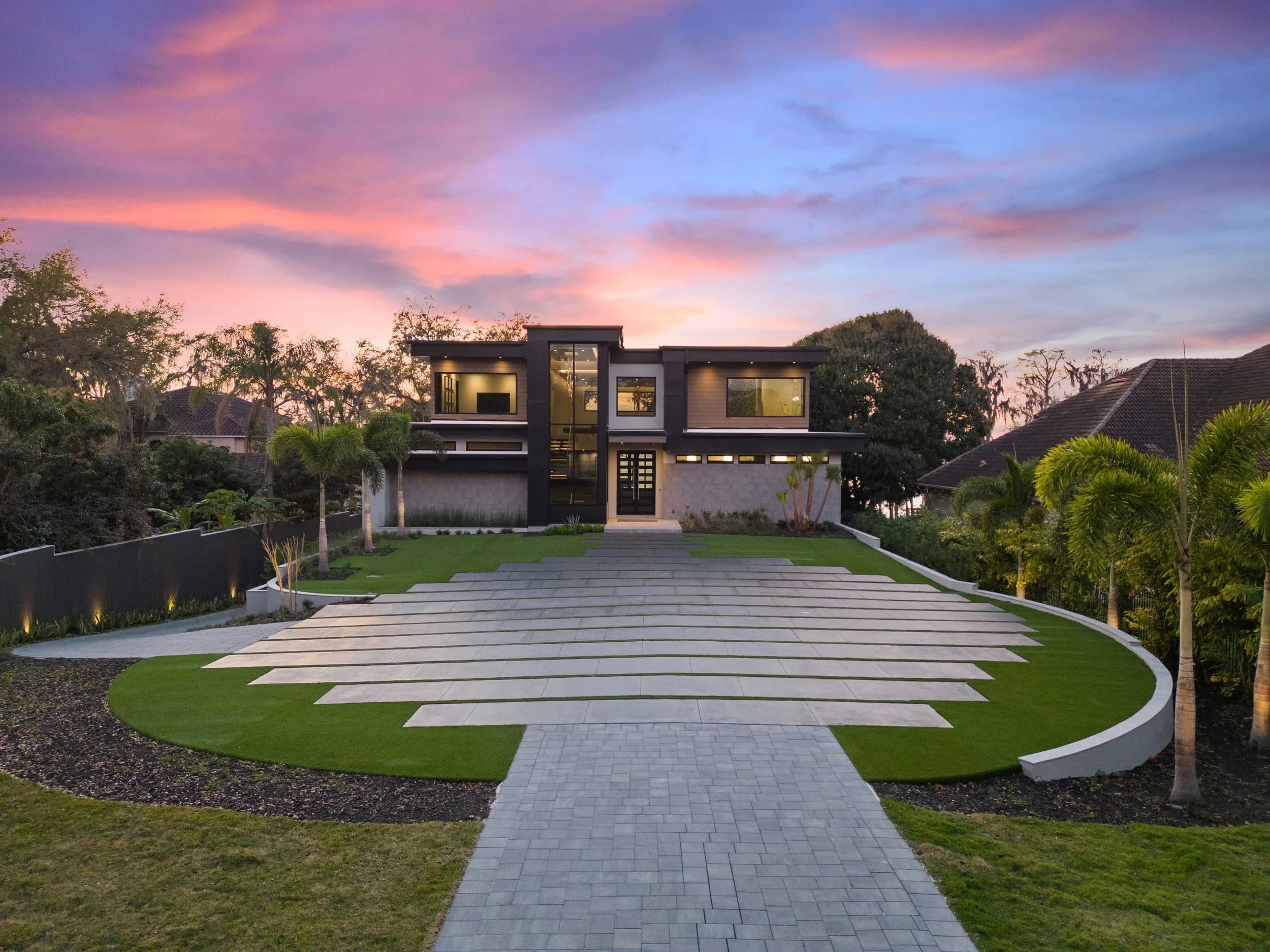 Twilight exterior of a luxury Orlando home lit at the motor court, a listing exterior by JRP