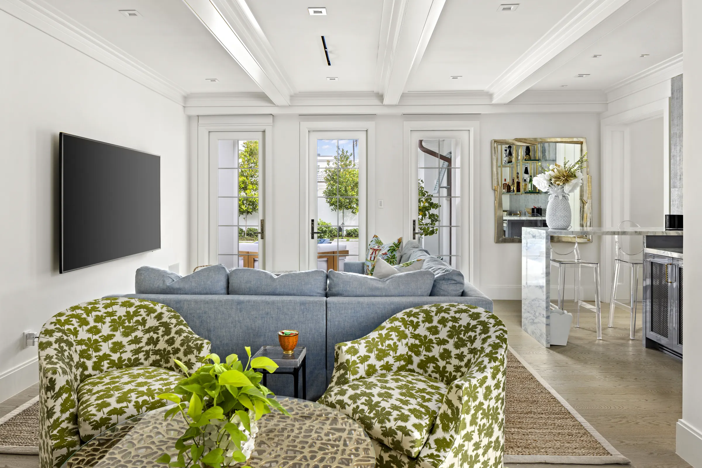 Family room with coffered ceiling and garden windows