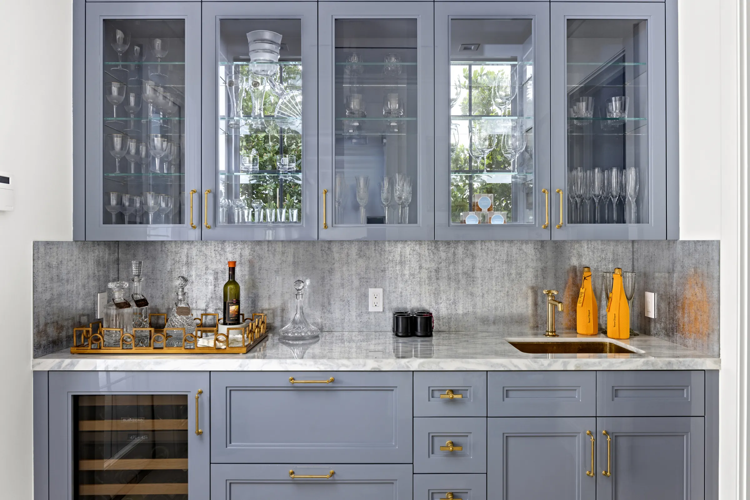 Bar with glass-front blue cabinets and wine storage