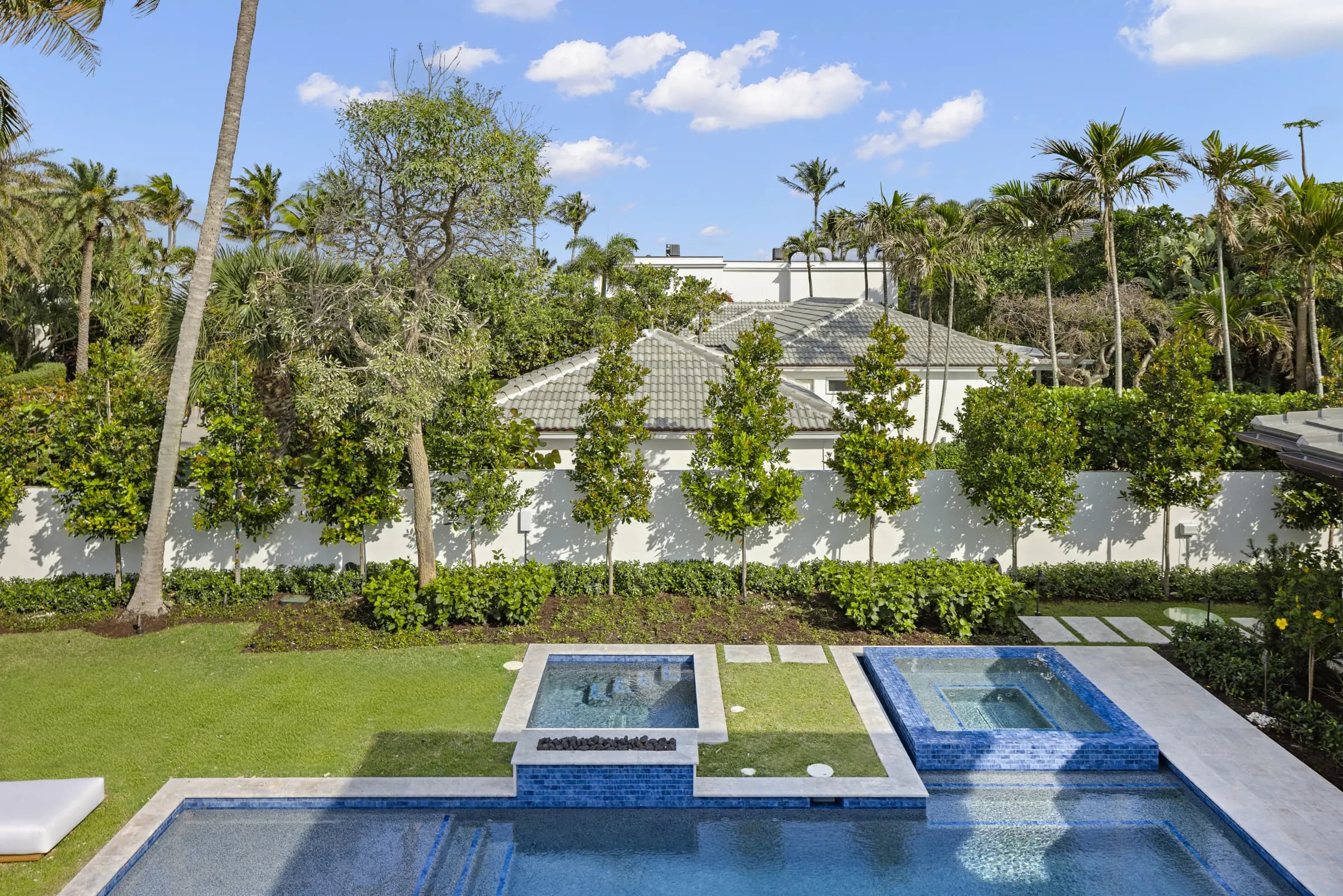 Pool and spa from the upper balcony, with the hedges and palms