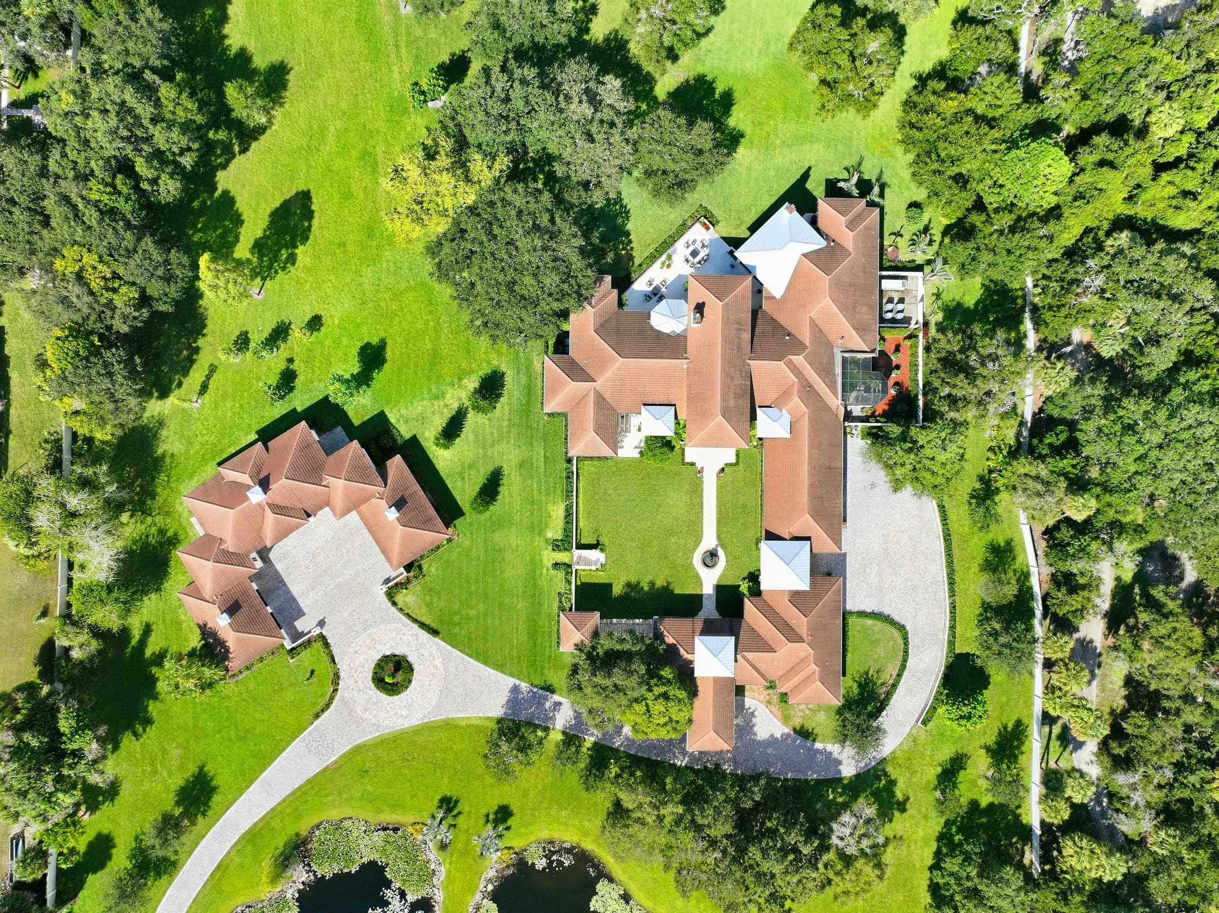 Top-down aerial of the main house, guest house, motor court and gardens
