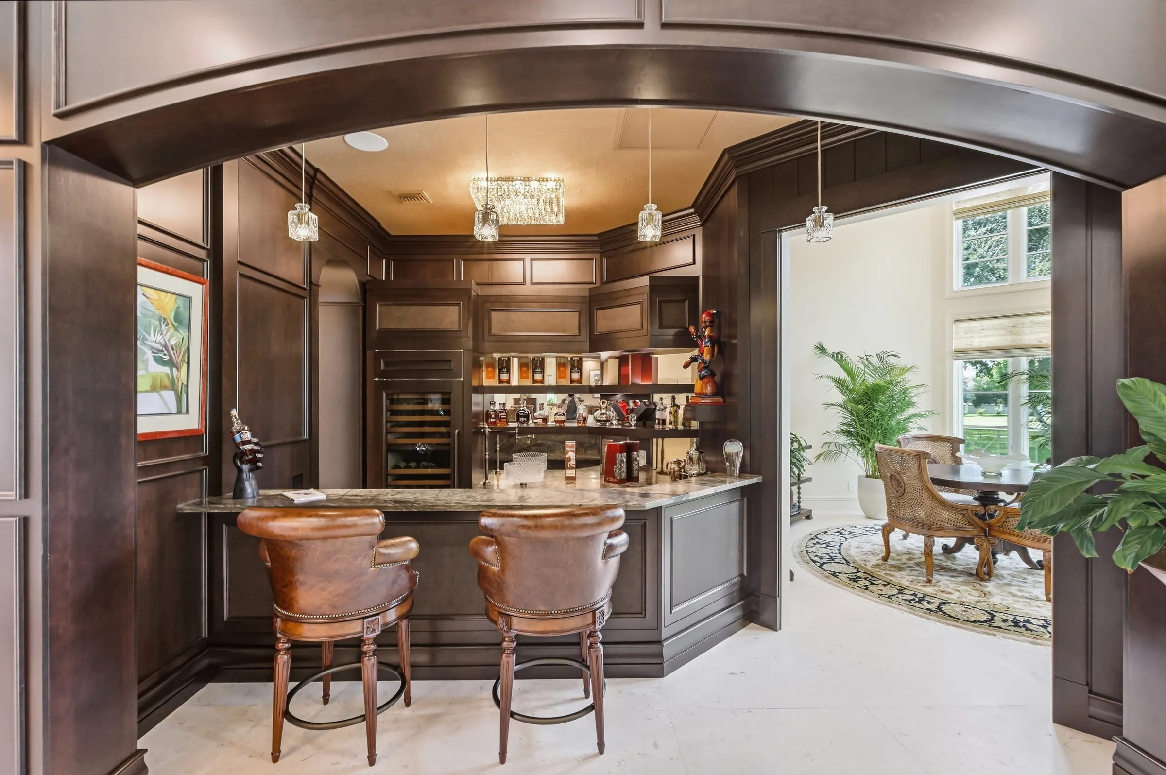 Custom mahogany entertainment bar under an arched opening