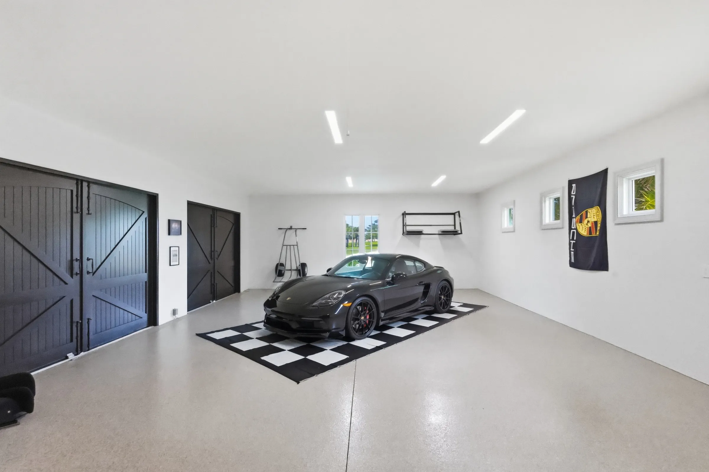 Nine-car garage with mahogany cabinetry and a sports car